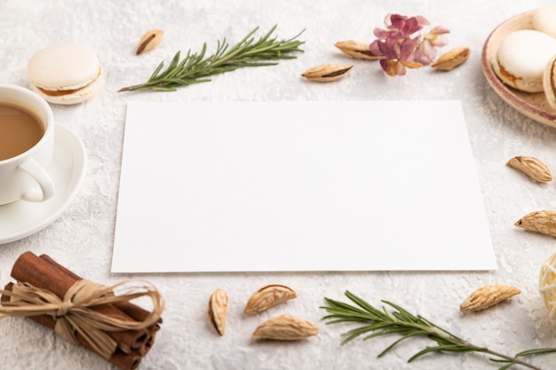 White paper sheet with cup of coffee, almonds and macaroons 