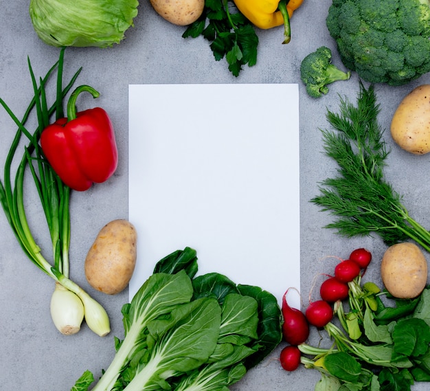 White paper and vegetables on a table.