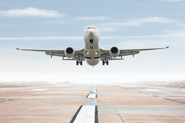 White passenger jet plane take off from airport runway