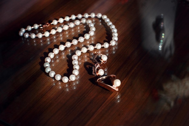 White pearl necklace on a wooden background