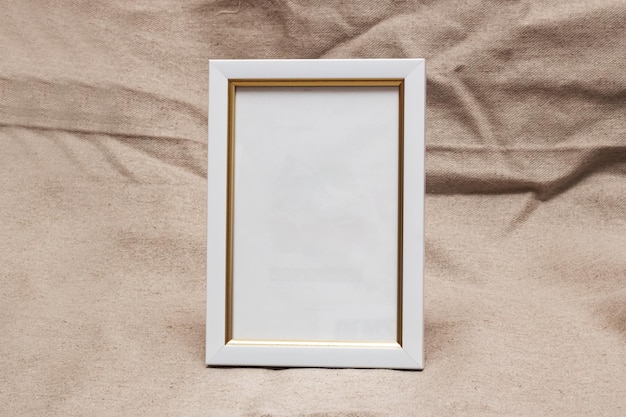 White photo frame on burlap fabric background