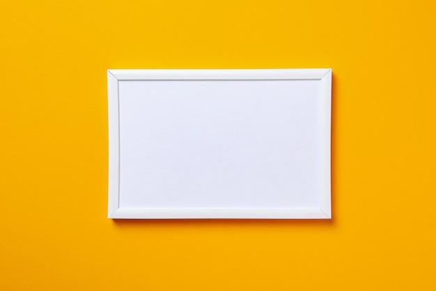 White photo frame on a yellow background