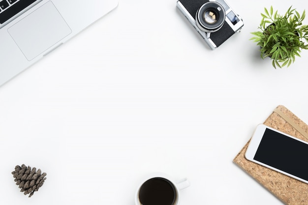 White photographer desk table with film camera, laptop and supplies. 