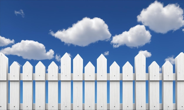 Photo white picket fence against a blue sky with white clouds