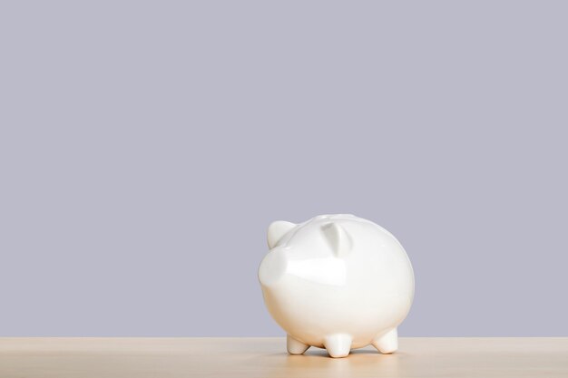 Photo white piggy bank on gray background money saving concept