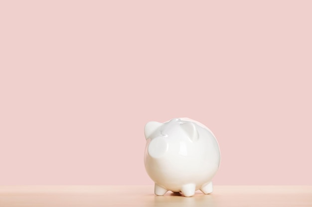 Photo white piggy bank on pink background money saving concept