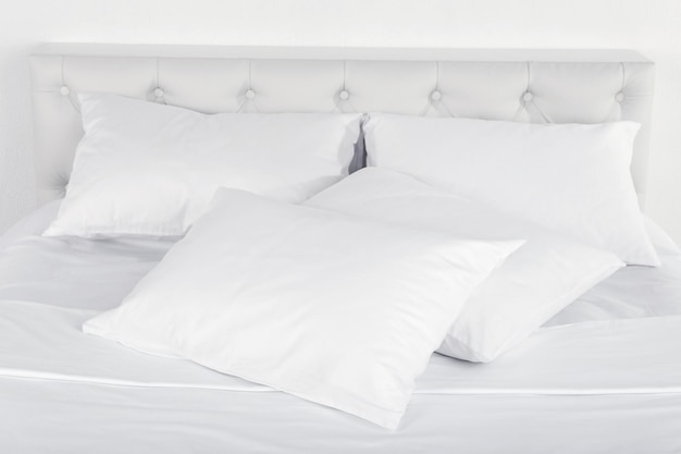 White pillows on bed in room