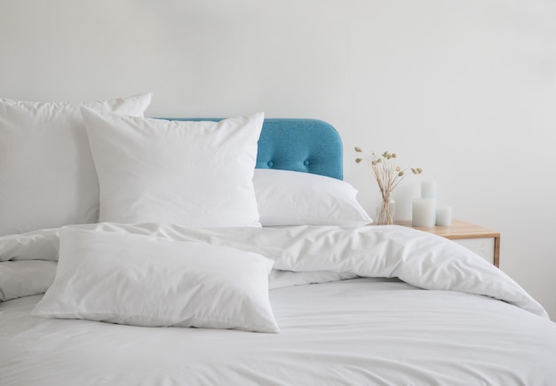 White pillows and duvet on the blue bed.