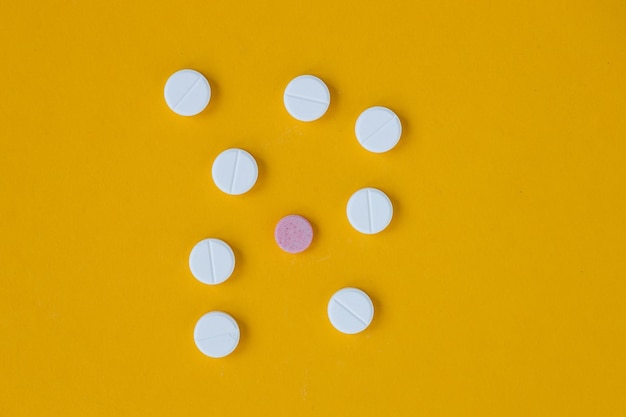 White pills on a yellow background