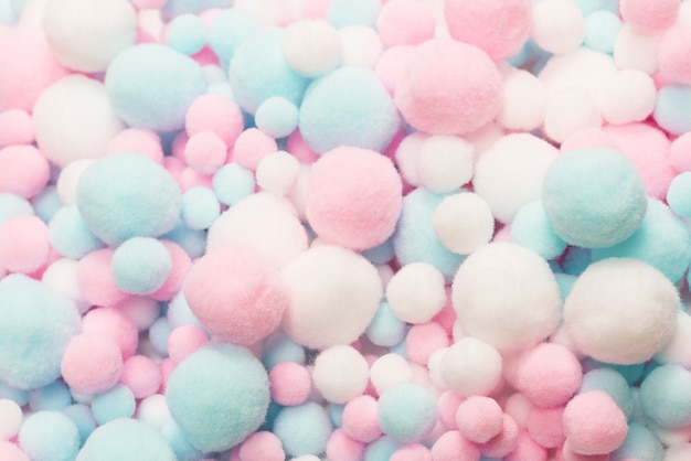 White, pink and blue soft pompons background.