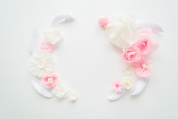 White and pink paper flowers on white