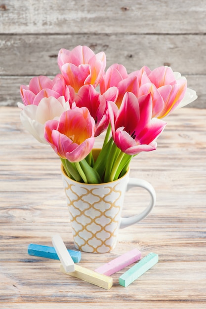 White and pink tulips and pastel colored chalks