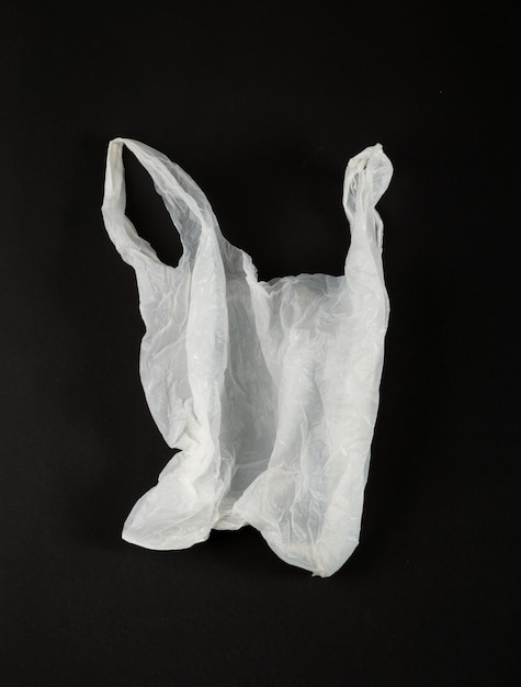 White Plastic Bags on Black Background Crumpled Plastic Bag after Shopping Cellophane Packaging Waste Used Crumpled Disposable Pouch