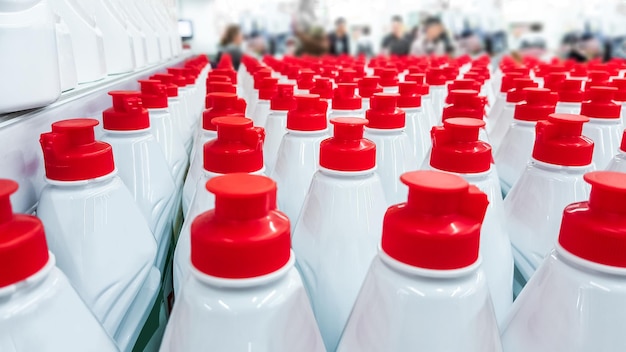 White plastic bottles with red lids in a row