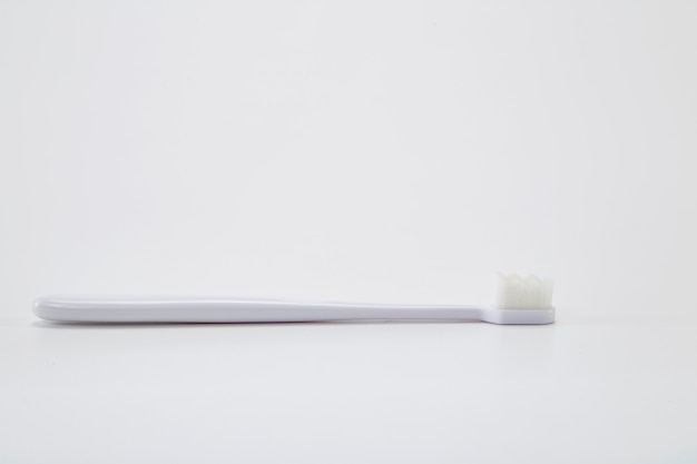 White plastic toothbrush with white bristle  table