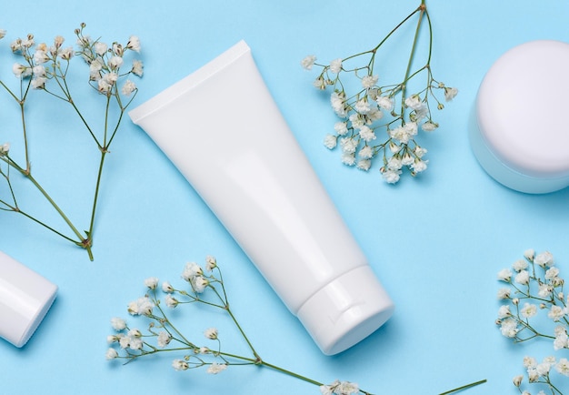 White plastic tube on a blue background container for cosmetics