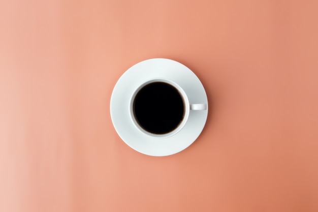 White plate, cup of coffee on beige background. High quality photo