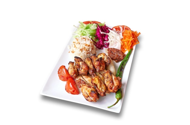 White plate with Chicken drumsticks and vegetables Isolated on withe