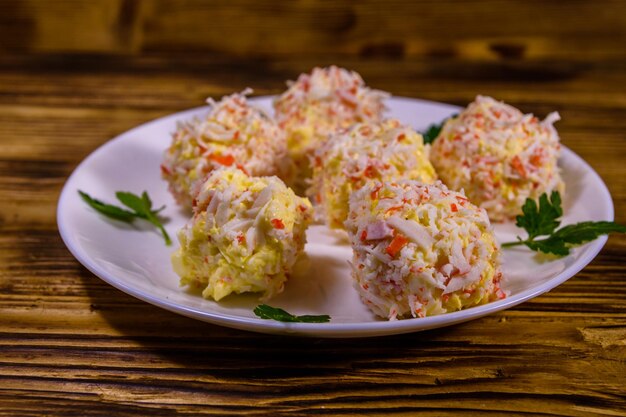 White plate with crabcheese balls on rustic wooden table