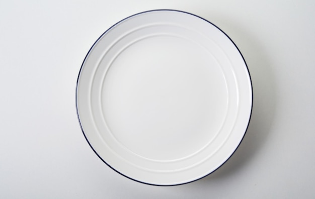 White plate with rim and raised pattern