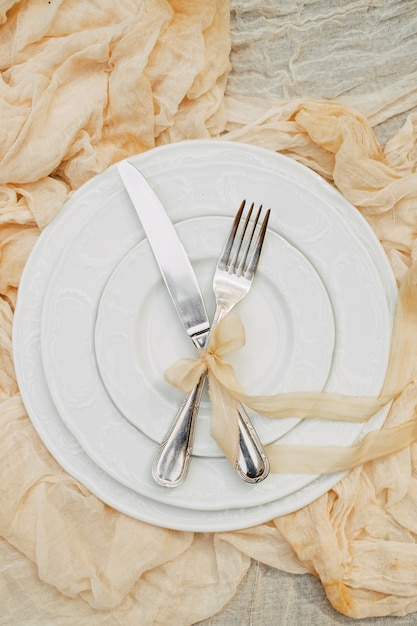 White plates, fork, knife and decoration