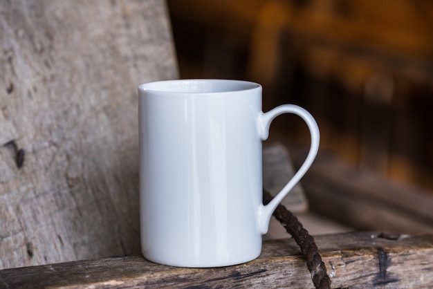 White porcelain coffee cup, mug on old wooden table