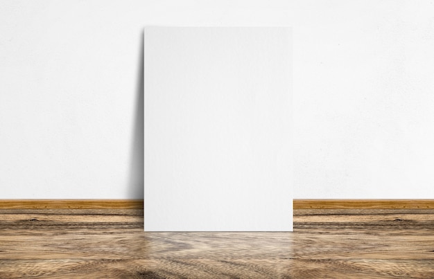 White poster leaning at rustic wooden floor and white wall