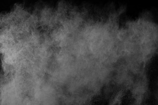 White powder explosion on black background. Colored cloud. Colorful dust explode. Paint Holi. 