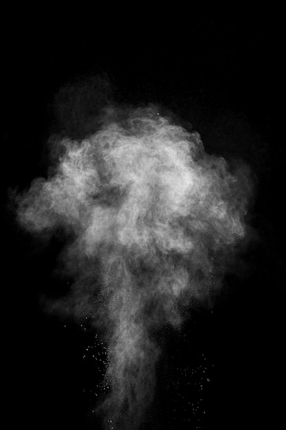 White powder explosion isolated on black background. White dust particles splash.Color Holi Festival.