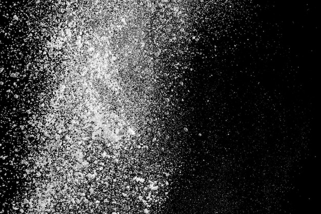 White powder explosion isolated on black background