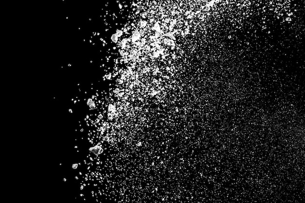 White powder explosion isolated on black