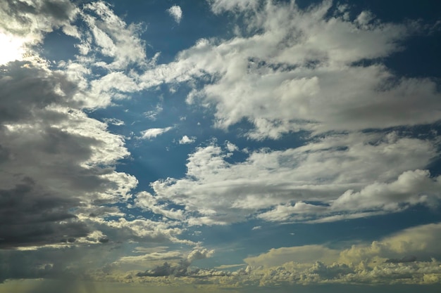 White puffy cumulus clouds on summer blue sky