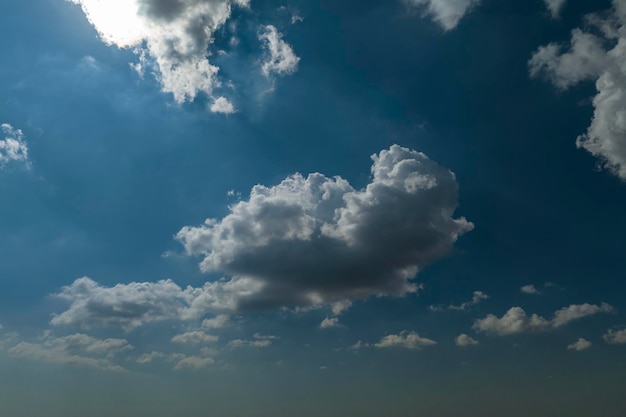 White puffy cumulus clouds on summer blue sky