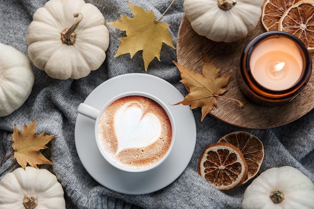 White pumpkins coffee and autumn leaves