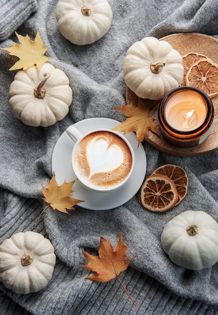 White pumpkins coffee and autumn leaves