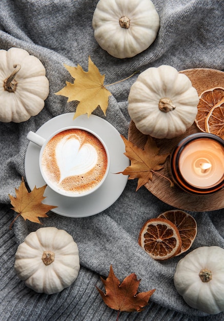 White pumpkins coffee and autumn leaves