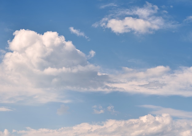 White pure fluffy clouds on a blue sky. Background image, without people. Siberia, Russia, 2020