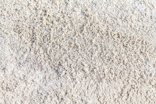 White quartz sand on the beach in the fall as a background