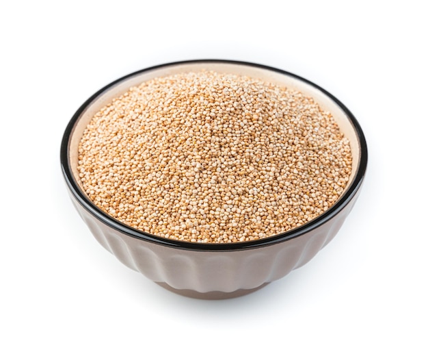 White quinoa seeds in a brown bowl are isolated on a white background in the bowl Side view