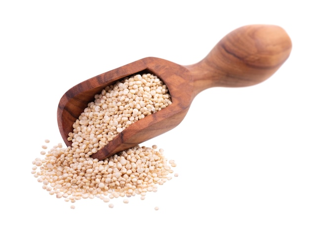 White quinoa seeds in wooden scoop isolated on white background Pile of raw kinwa