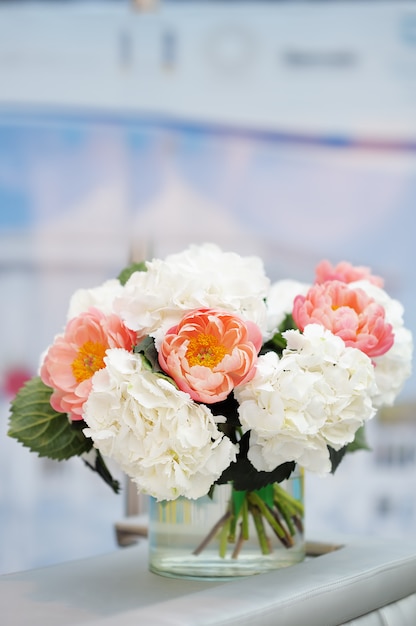 White and red flowers bouquet in glass vase 