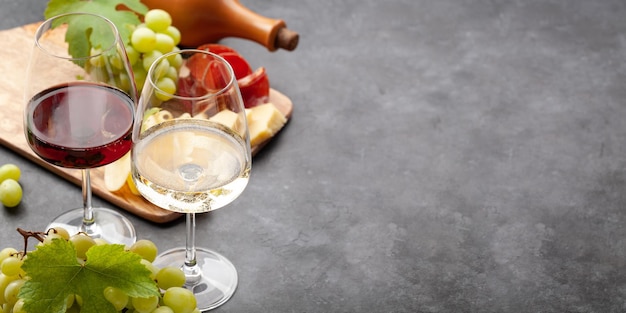 White and red wine glasses grape and appetizer board