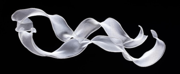 White ribbon long straight fly in air with curve roll shiny White snow ribbon for present gift birthday party to wrap around decorate curl curve long straight Black background isolated