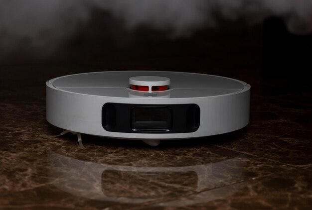 A white robot vacuum cleaner on a brown tile