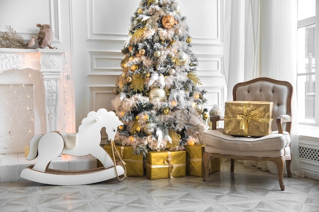 White room interior in red tones with New Year tree decorated