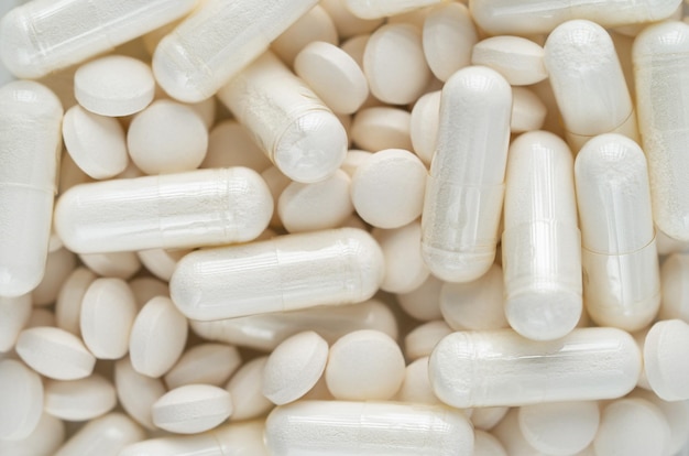 White round pills and capsules texture Overhead close up