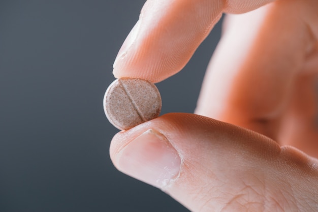 white round tablet in hand