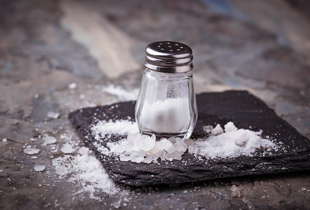 Photo white salt in shaker. selective focus