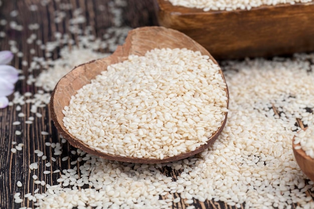 White sesame seeds on a wooden table