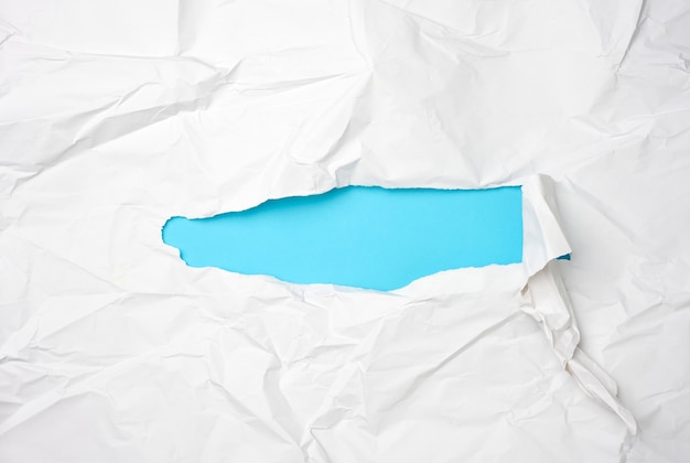 White sheet of paper with a hole, full frame, blue inside